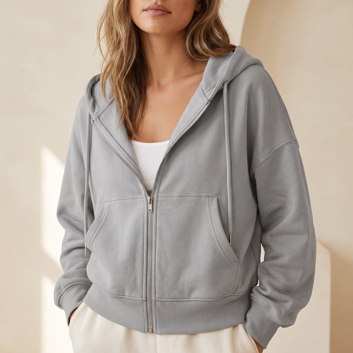 Felpa donna con zip intera e cappuccio con coulisse in grigio, indossata